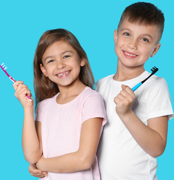 two-kids-smiling-holding-a-toothbrush