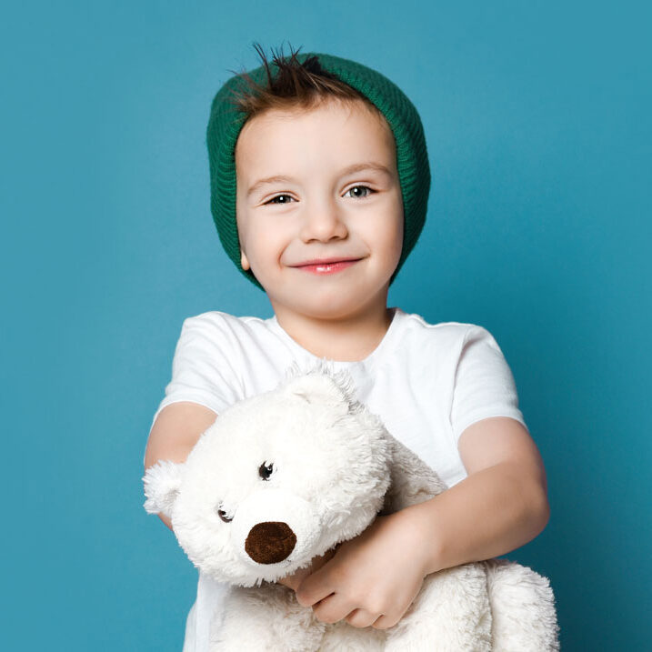 smiling-little-boy-holding-stuffed-polar-bear-toy-square
